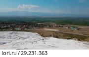 Panorama view from above on Pamukkale . Aerial view of Hierapolis Ancient Greco-Roman city in Turkey. Стоковое видео, видеограф Сергей Тимофеев / Фотобанк Лори