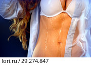 Sexual woman drinking water from bottle, pours on breasts. Стоковое фото, фотограф Gennadiy Poznyakov / Фотобанк Лори