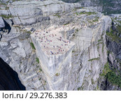 Flat rock Preikestolen over fjord Lysefjorden is natural attraction. Top view and flight down above cliff. Preacher's Pulpit or Preacher's Chair is in Forsand in Rogaland, Norway (2018 год). Стоковое фото, фотограф Кекяляйнен Андрей / Фотобанк Лори