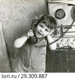 Маленькая девочка разговаривает по телефону. Редакционное фото, фотограф Retro / Фотобанк Лори