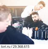 client feeling discontent about his new haircut at hair salon. Стоковое фото, фотограф Яков Филимонов / Фотобанк Лори