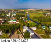 Beautiful panoramic view of Suzdal in summer at sunrise. Resurrection Church on the market square in Suzdal. Suzdal is a famous tourist attraction and part of the Golden Ring of Russia. Стоковое фото, фотограф Mikhail Starodubov / Фотобанк Лори