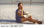 happy smiling girl enjoying the sunset, eating watermelon, sit on salt, pillars. Стоковое видео, видеограф Ирина Мойсеева / Фотобанк Лори