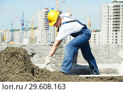Roof construction. worker roofer leveling with float lute. Стоковое фото, фотограф Дмитрий Калиновский / Фотобанк Лори