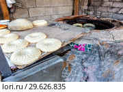 Uzbek flatbread is preparing to put in the tandyr. Стоковое фото, фотограф FotograFF / Фотобанк Лори