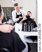 Glad man client discussing his future haircut. Стоковое фото, фотограф Яков Филимонов / Фотобанк Лори