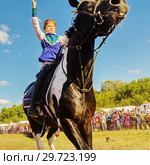 Russia, Samara, July, 2018: a Cossack girl rides a horse and performs tricks. Редакционное фото, фотограф Акиньшин Владимир / Фотобанк Лори