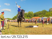 Russia, Samara, July, 2018: a Cossack girl rides a horse and performs tricks. Редакционное фото, фотограф Акиньшин Владимир / Фотобанк Лори