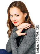 young beautiful woman in gray jumper folded her hands near her face and smiles. isolated on white background. Стоковое фото, фотограф Евгения Филимонова / Фотобанк Лори