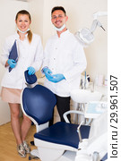 Orthodontist in white with his assistent are meeting next client near the chair. Стоковое фото, фотограф Яков Филимонов / Фотобанк Лори