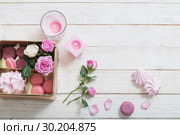 rose, desset and candles on white wooden background. Стоковое фото, фотограф Майя Крученкова / Фотобанк Лори