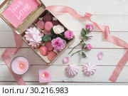 rose, desset and candles on white wooden background. Стоковое фото, фотограф Майя Крученкова / Фотобанк Лори