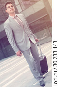 Businessman walking with travel bag. Стоковое фото, фотограф Яков Филимонов / Фотобанк Лори