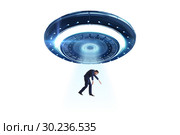 Flying saucer abducting young businessman. Стоковое фото, фотограф Elnur / Фотобанк Лори