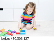 Lovely little girl playing with educational toy at home. Стоковое фото, фотограф ivolodina / Фотобанк Лори