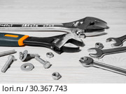Adjustable spanners and wrenches, nuts and bolts on the table. Стоковое фото, фотограф Евгений Харитонов / Фотобанк Лори