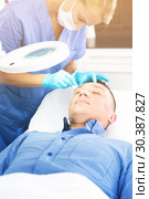 Female doctor is doing cleaning skin procedure to client. Стоковое фото, фотограф Яков Филимонов / Фотобанк Лори
