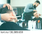 Male hairdresser accurately cutting beard. Стоковое фото, фотограф Яков Филимонов / Фотобанк Лори