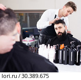 client feeling discontent about his new haircut at hair salon. Стоковое фото, фотограф Яков Филимонов / Фотобанк Лори