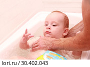 Father teaching baby to swim. Portrait of a charming 7 months child in the classroom in a swimming pool. Healthy Family Life. Стоковое фото, фотограф Дубровская Татьяна / Фотобанк Лори