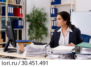 Female employee with too much work in the office. Стоковое фото, фотограф Elnur / Фотобанк Лори