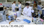 Scientific researching in laboratory. Two young scientists mixing reagents in test tube with lab pipette. Стоковое видео, видеограф Яков Филимонов / Фотобанк Лори