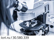 Helth care professional microscoping on hi-tec fluorescent microscope. Стоковое фото, фотограф Matej Kastelic / Фотобанк Лори
