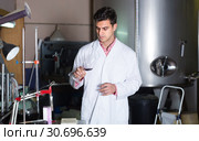 Positive male laboratorian working with wine. Стоковое фото, фотограф Яков Филимонов / Фотобанк Лори