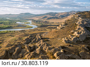 Beautiful landscape in the evening sunlight. Mtkvari river on the background of the Caucasus Mountains, view from the cave city Uplistsikhe, Georgia. Стоковое фото, фотограф Юлия Бабкина / Фотобанк Лори