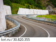 A view of a curved road. Driving a car on mountain road. Asphalt road in mountain. Empty road background. Стоковое фото, фотограф Андрей Холмов / Фотобанк Лори