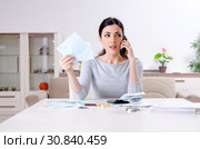 Young woman in budget planning concept. Стоковое фото, фотограф Elnur / Фотобанк Лори