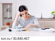 Young woman in budget planning concept. Стоковое фото, фотограф Elnur / Фотобанк Лори