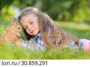 Girl with a cute little rabbit, outdoor, summer day. Стоковое фото, фотограф Чирцова Наталья / Фотобанк Лори