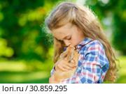 Girl with a cute little rabbit, outdoor, summer day. Стоковое фото, фотограф Чирцова Наталья / Фотобанк Лори