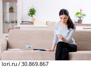 Young woman in budget planning concept. Стоковое фото, фотограф Elnur / Фотобанк Лори