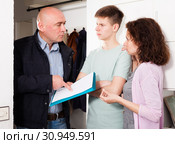 Householder demanding woman with son to pay arrears. Стоковое фото, фотограф Яков Филимонов / Фотобанк Лори