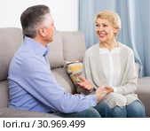 friendly mature married couple in house are warmly reconciled after quarrel. Стоковое фото, фотограф Яков Филимонов / Фотобанк Лори
