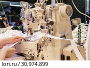 Industrial overlock sewing machine in work. Стоковое фото, фотограф Евгений Харитонов / Фотобанк Лори