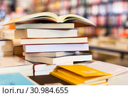 stack of books lying on table in bookstore. Стоковое фото, фотограф Татьяна Яцевич / Фотобанк Лори