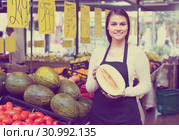 Seller with melon in market. Стоковое фото, фотограф Яков Филимонов / Фотобанк Лори