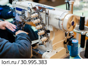 Industrial overlock sewing machine in work. Стоковое фото, фотограф Евгений Харитонов / Фотобанк Лори