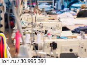 Industrial sewing machines in a garment workshop. Стоковое фото, фотограф Евгений Харитонов / Фотобанк Лори
