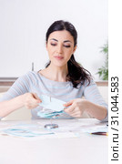 Young woman in budget planning concept. Стоковое фото, фотограф Elnur / Фотобанк Лори