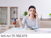 Young woman in budget planning concept. Стоковое фото, фотограф Elnur / Фотобанк Лори