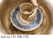 Potter's hand mold pottery on a rotating wheel. Стоковое фото, фотограф Евгений Харитонов / Фотобанк Лори