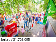 Russia Samara June 2019: a girl passes the standards for pulling up on a horizontal bar in the park sunny day. Text in Russian: Judge Gto. Редакционное фото, фотограф Акиньшин Владимир / Фотобанк Лори