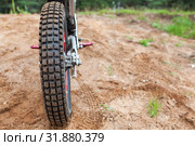 Skid-resistant tread on motorcycle tire, motocross bike in sandy track, rear view. Стоковое фото, фотограф Кекяляйнен Андрей / Фотобанк Лори