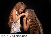 Девочка ущипнула рукой за нос другую девочку. Стоковое фото, фотограф Иванов Алексей / Фотобанк Лори