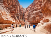 Tourists in narrow passage of rocks of Petra canyon in Jordan. Petra has been a UNESCO World Heritage Site since 1985. Way through Siq gorge to stone city Petra (2012 год). Редакционное фото, фотограф Наталья Волкова / Фотобанк Лори