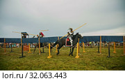 BULGAR, RUSSIA 11-08-2019: Knights having a battle on the green field - running on each other and breaking the plastic spear. Редакционное видео, видеограф Константин Шишкин / Фотобанк Лори